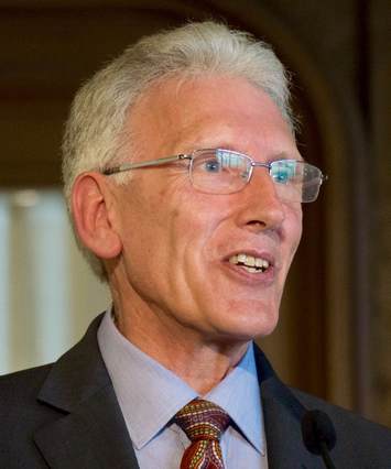 John Bond portrait, speaking in meeting