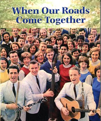 Group of people singing, with Colwell brothers in front