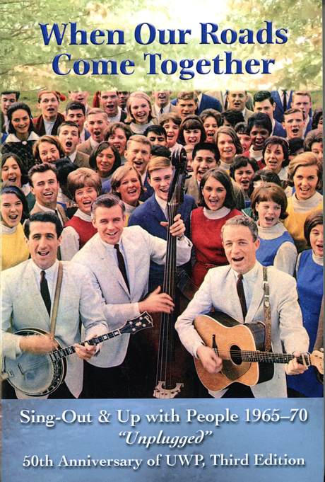 Group of people singing, with Colwell brothers in front
